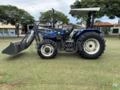 Trator New Holland TL75E 4x4 2005 com conjunto de concha dianteiro Imagem Trator New Holland TL75E 4x4 2005 com conjunto de concha dianteiro