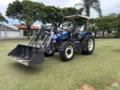 Trator New Holland TL75E 4x4 2005 com conjunto de concha dianteiro Imagem Trator New Holland TL75E 4x4 2005 com conjunto de concha dianteiro